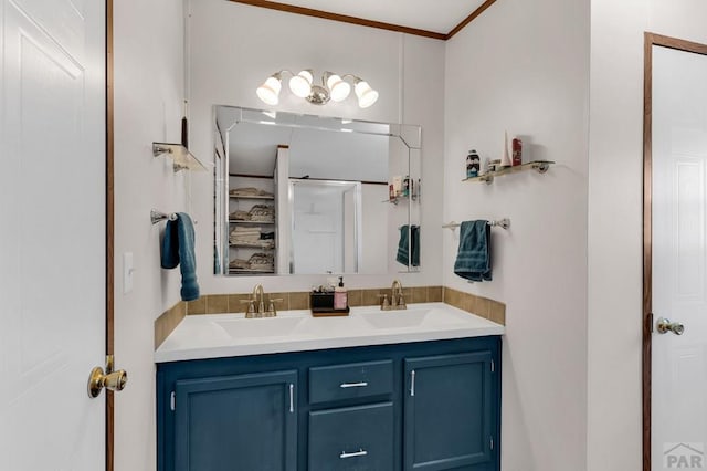 full bathroom with a sink, ornamental molding, double vanity, and a stall shower