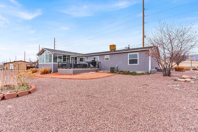 back of house featuring central air condition unit and a sunroom