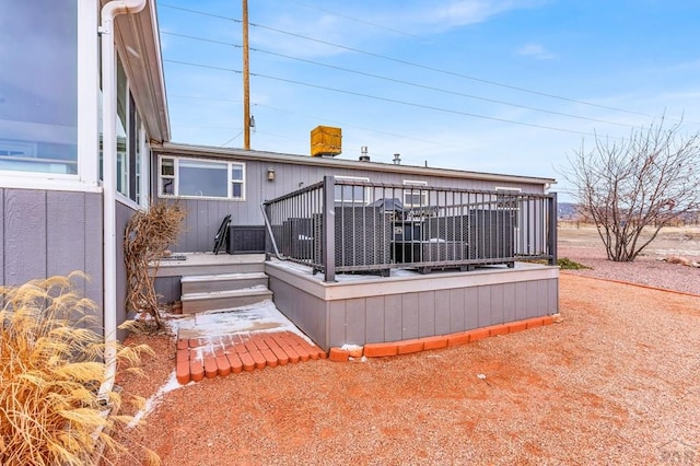 rear view of house featuring a wooden deck