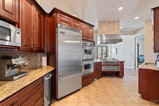 kitchen featuring light stone countertops, recessed lighting, decorative backsplash, appliances with stainless steel finishes, and a warming drawer