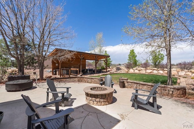 view of patio / terrace with an outdoor fire pit and a gazebo