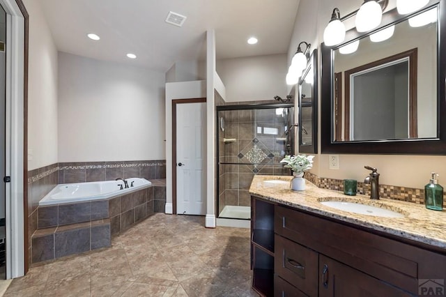 full bathroom featuring visible vents, a stall shower, recessed lighting, a garden tub, and vanity
