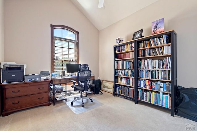 home office featuring ceiling fan, vaulted ceiling, and carpet