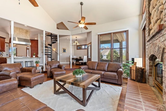 living area with light wood finished floors, stairway, a fireplace, a ceiling fan, and plenty of natural light