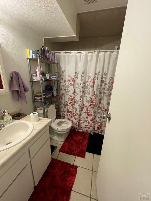 bathroom featuring visible vents, toilet, tile patterned flooring, a textured ceiling, and vanity