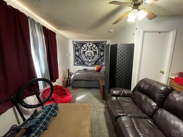 home theater with a textured ceiling, carpet, lofted ceiling, and a ceiling fan