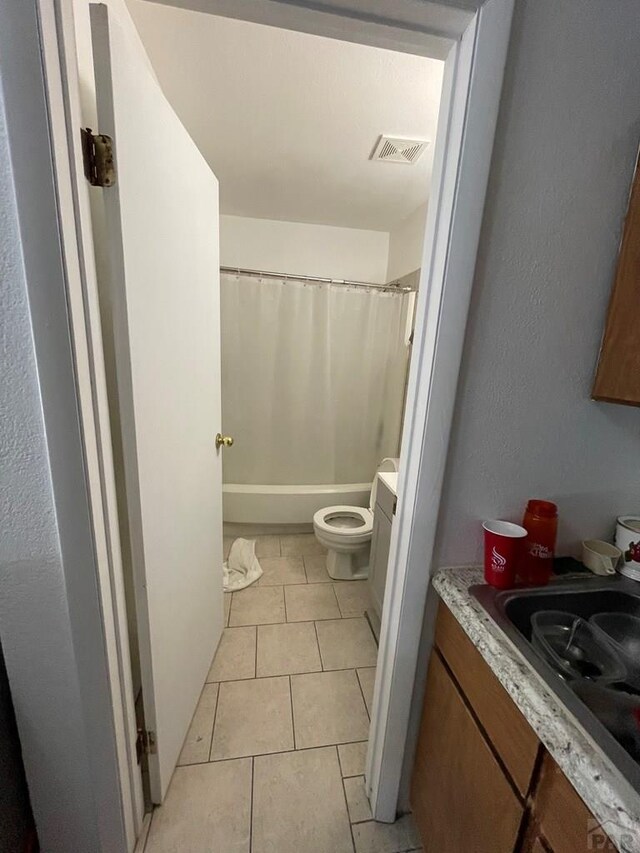 bathroom with toilet, tile patterned flooring, vanity, and visible vents