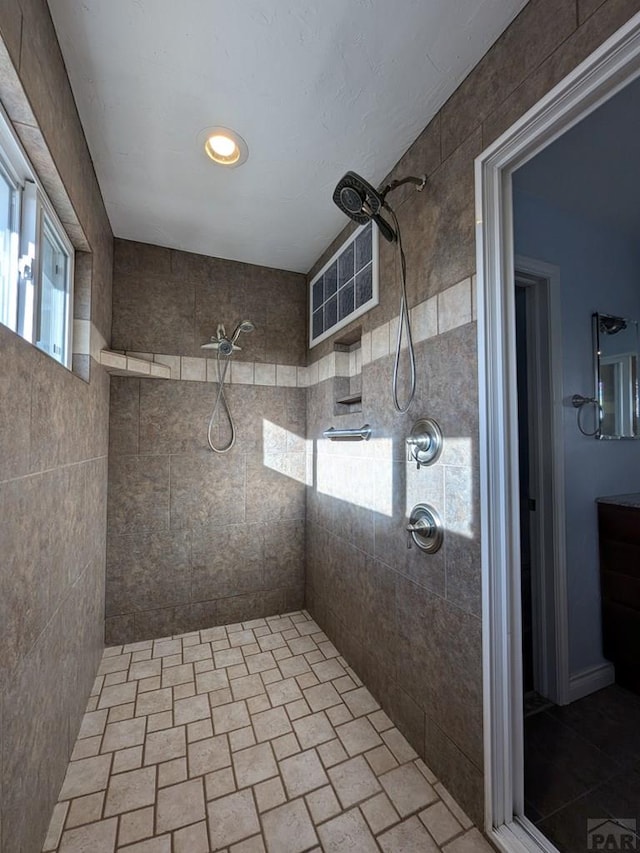 bathroom featuring a healthy amount of sunlight and a tile shower