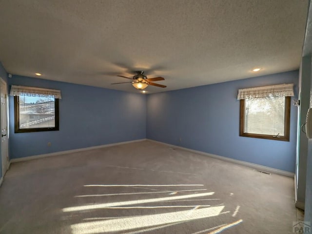 unfurnished room featuring carpet flooring, a healthy amount of sunlight, and baseboards