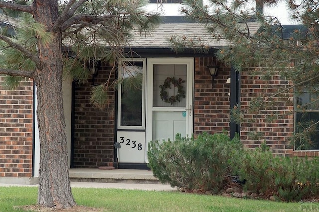 property entrance with brick siding