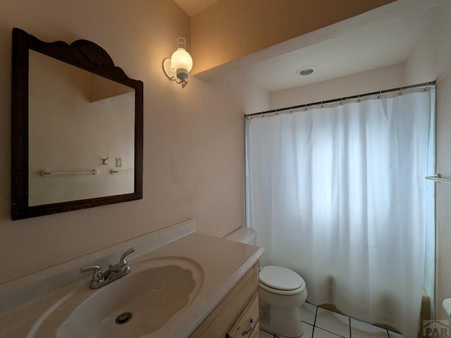 bathroom featuring vanity, toilet, and tile patterned floors