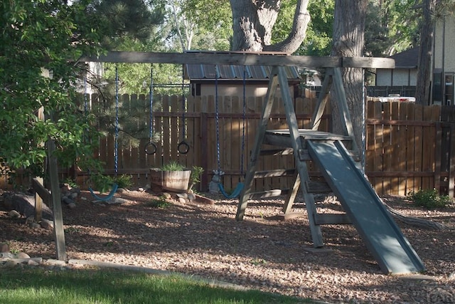 view of jungle gym featuring fence