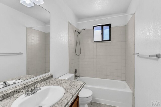 bathroom featuring toilet,  shower combination, and vanity