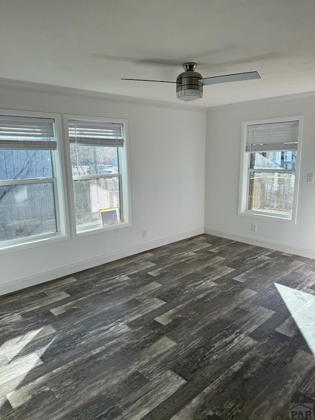 unfurnished room with dark wood-style floors, plenty of natural light, and baseboards