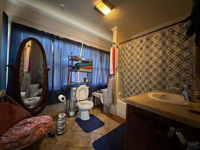 full bathroom featuring tile patterned flooring, vanity, toilet, and shower / bath combo with shower curtain