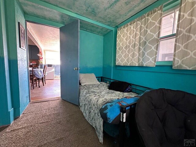 bedroom with a textured ceiling and carpet