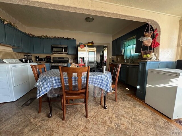 dining room featuring ornamental molding and washing machine and clothes dryer