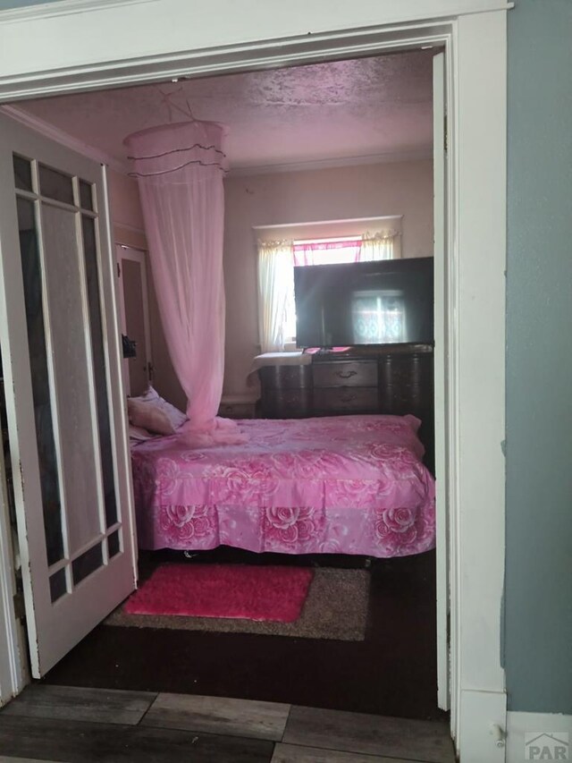 unfurnished bedroom featuring dark wood-style flooring and a textured ceiling