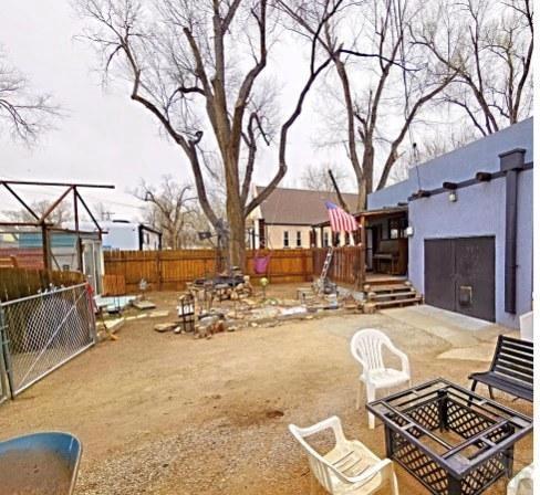view of yard featuring an outdoor fire pit, a fenced backyard, and a patio area