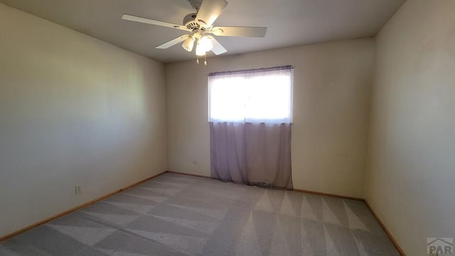 unfurnished room with light carpet, ceiling fan, and baseboards