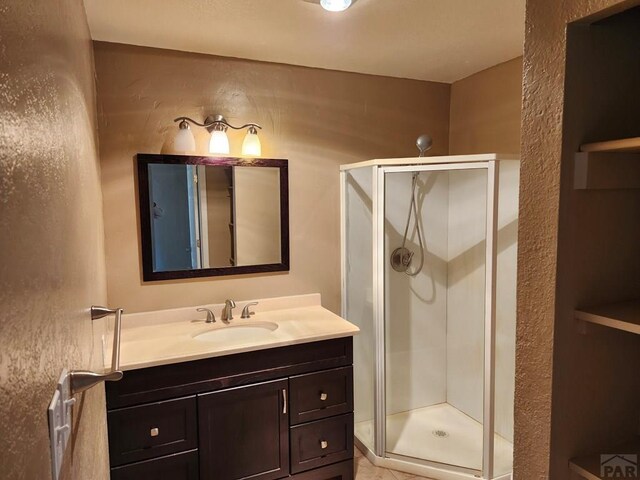 7787 State Highway 78, Beulah, CO 81023 - full bath featuring vanity, a shower stall, and a textured wall