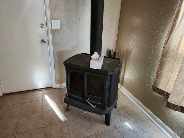7787 State Highway 78, Beulah, CO 81023 - detailed view of a textured wall, baseboards, and a wood stove