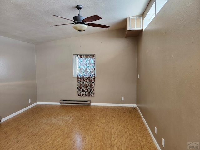 7787 State Highway 78, Beulah, CO 81023 - spare room with a baseboard radiator, a ceiling fan, wood finished floors, a textured ceiling, and baseboards
