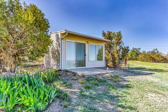 181 6th St, Penrose, CO 81240 - rear view of property with a patio and a lawn