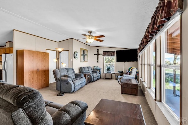 181 6th St, Penrose, CO 81240 - living area featuring light colored carpet, ceiling fan, and vaulted ceiling