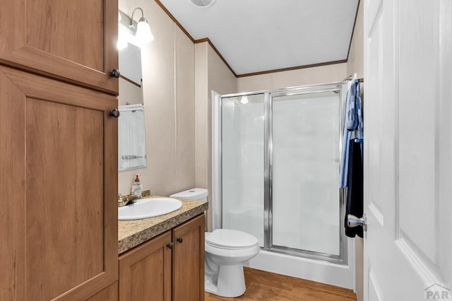 181 6th St, Penrose, CO 81240 - bathroom with a stall shower, vanity, ornamental molding, toilet, and wood finished floors