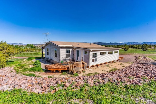 181 6th St, Penrose, CO 81240 - back of property with a deck with mountain view and metal roof