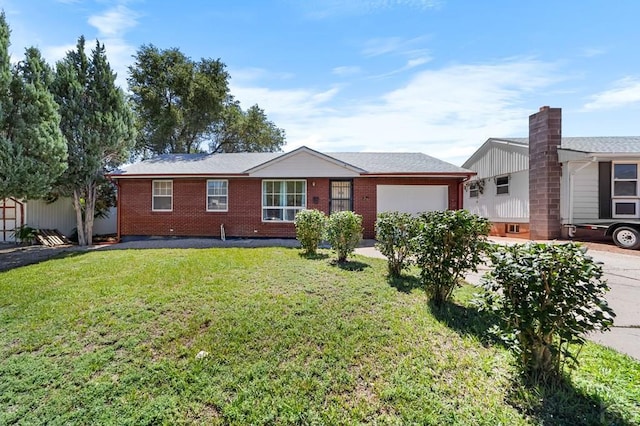 ranch-style house with an attached garage, a front lawn, concrete driveway, and brick siding