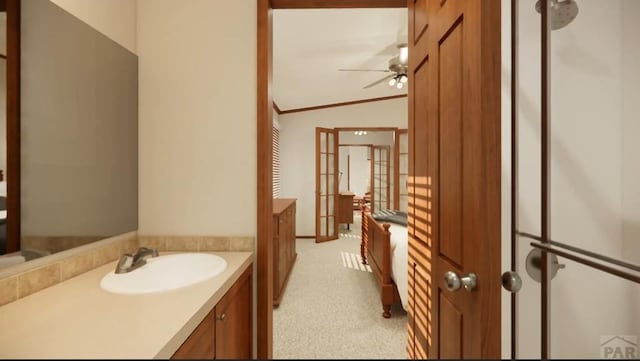 bathroom with ornamental molding, vaulted ceiling, a sink, and ceiling fan