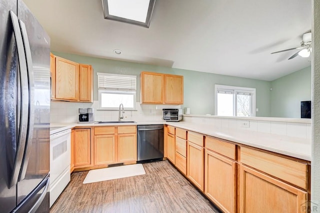 1493 N Challenger Ln, Pueblo West, CO 81007 - kitchen with dishwasher, freestanding refrigerator, light brown cabinetry, a sink, and electric stove