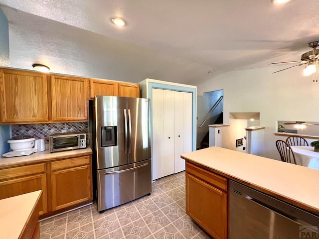 kitchen featuring tasteful backsplash, ceiling fan, appliances with stainless steel finishes, and light countertops