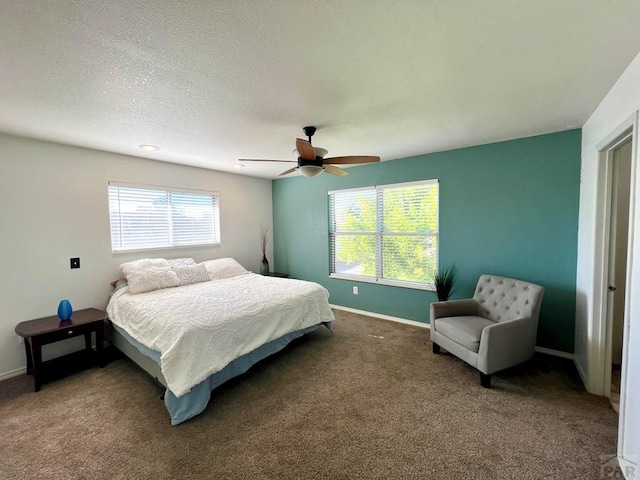 bedroom with a ceiling fan, carpet flooring, a textured ceiling, and baseboards