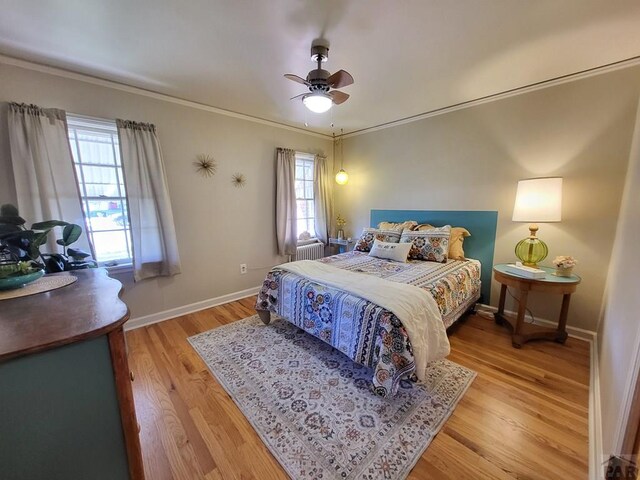 bedroom with ceiling fan, light wood-style flooring, baseboards, and ornamental molding