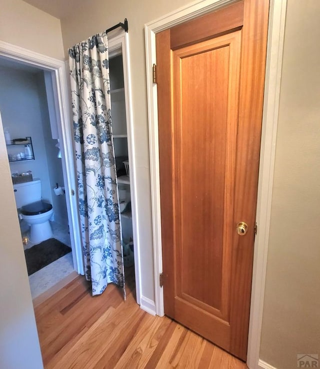 bathroom featuring toilet and wood finished floors