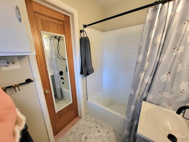 full bathroom with a sink and shower / bath combo with shower curtain