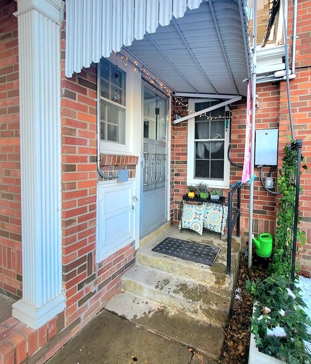 entrance to property with brick siding