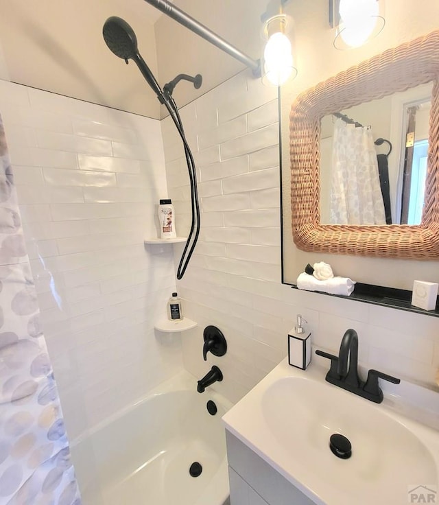 full bath featuring decorative backsplash, vanity, and shower / tub combo with curtain