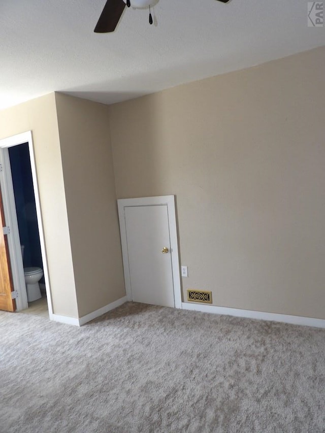 unfurnished room featuring carpet, ceiling fan, and baseboards