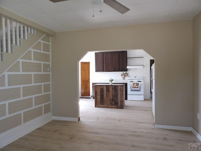 kitchen with white electric range, arched walkways, a ceiling fan, light wood finished floors, and open shelves