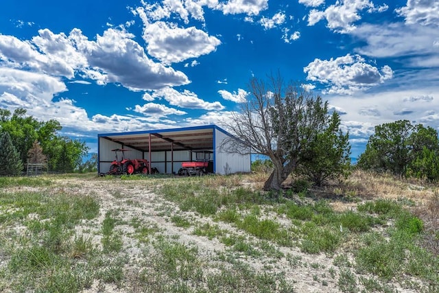 view of pole building featuring driveway and a carport
