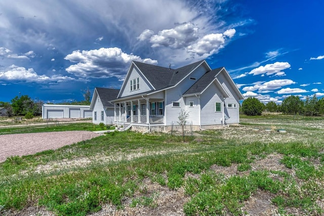 view of front of home with covered porch and an outdoor structure