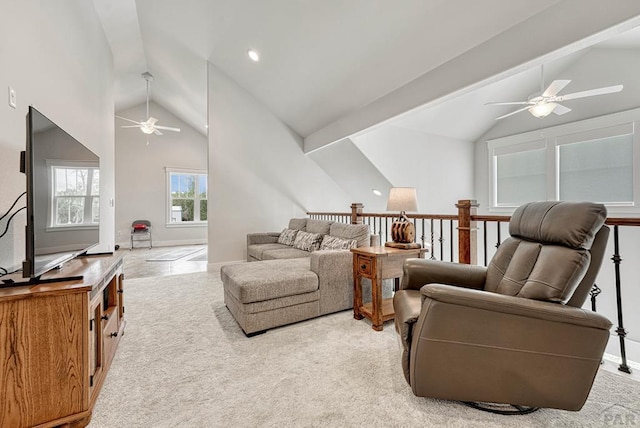 living area with baseboards, vaulted ceiling with beams, and a ceiling fan
