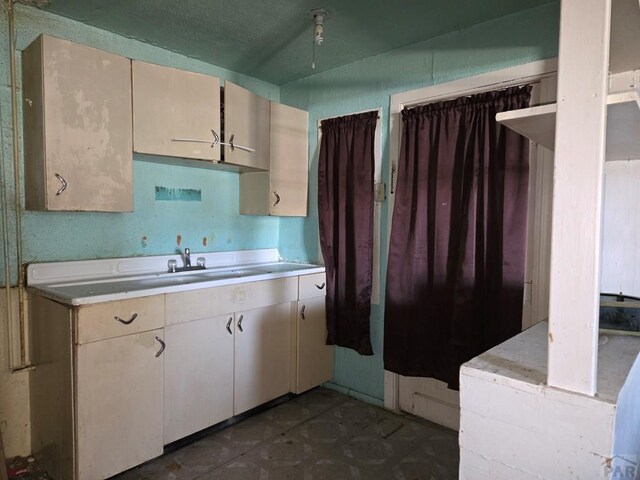 kitchen with light countertops and a sink