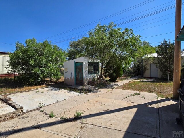 view of patio / terrace featuring an outbuilding and a shed