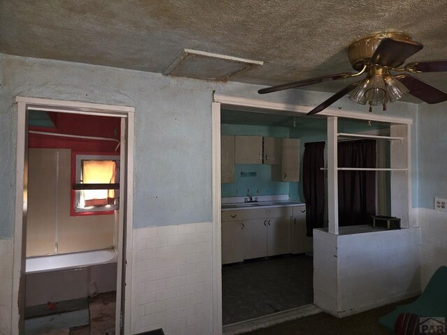 kitchen featuring light countertops, a sink, and a ceiling fan