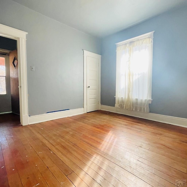 711 E 6th St, Pueblo, CO 81001 - unfurnished room with a healthy amount of sunlight, baseboards, and hardwood / wood-style floors